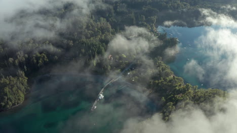 AERIAL---Nahuel-Huapi-Lake-through-the-clouds-in-Arrayanes-National-Park,-Neuquen,-Argentina,-forward-truck-right