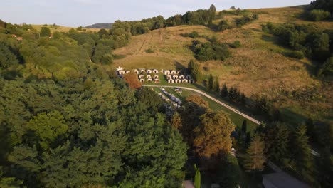 Flyover-above-small-cemetery,-mausoleums-near-Varbo,-Hungary-at-sunset