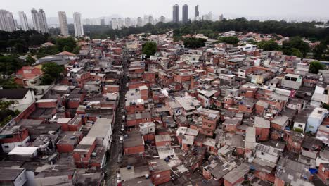 Aerial-view-over-suburban-dwellings-in-a-poverty-area,-in-cloudy-Sao-Paulo,-Brazil