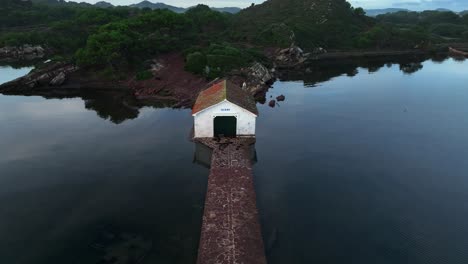 Fornells-Bay-in-Menorca-drone-reveal-with-lake-house-subject