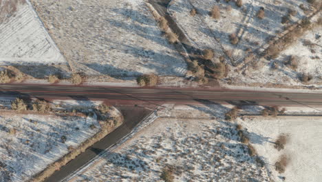 Top-down-aerial-shot-over-straight-road-in-rural-Oregon-USA-in-the-winter