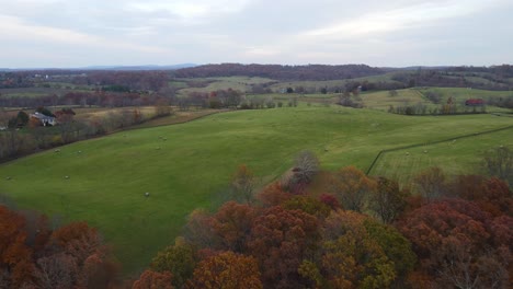 A-drone-shot-flying-over-a-majestic-farm-in-autumn