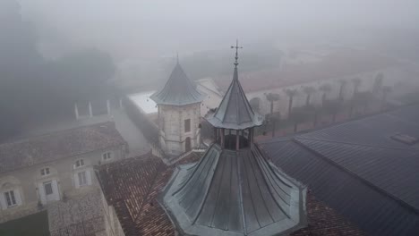 Chateau-Cos-d'Estournel-winery-on-foggy-day,-Bordeaux-region-of-France