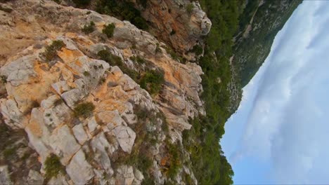 Stunning-aerial-drone-view-speeding-down-a-rocky-cliff-toward-the-ocean-on-the-Mediterranean-coast-of-Spain