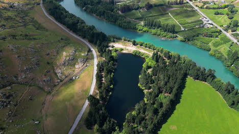 Scenic-Pinders-Pond-Freedom-Camping-by-Clutha-river,-New-Zealand,-aerial-view