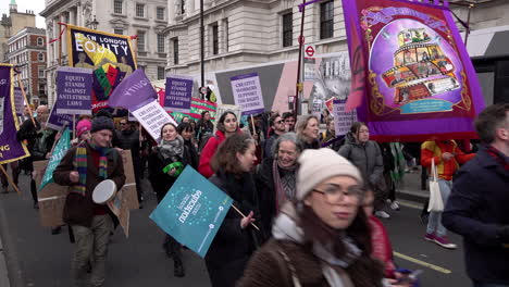 Demonstrators-hold-placards,-banners,-flags-and-march-along-Whitehall-on-the-National-Education-Union-national-strike-protest
