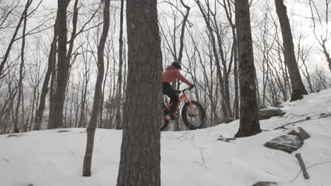 Female-cyclist-on-fat-bike-winter-snow-packed-trails