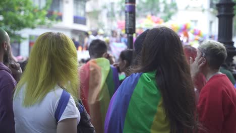Slow-motion-shot-of-many-people-with-colored-hairs-and-multicolored-flags-during-LGBT-Pride-Parade-event