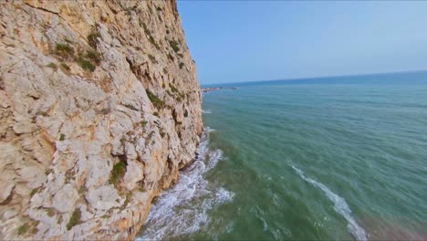 Aerial-drone-view-flying-along-the-spectacular,-rocky-cliffs-of-Garraf,-Spain-on-the-Mediterranean-coast