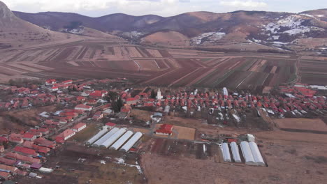Coltesti-village-and-church-seen-from-a-drone-at-winter,-aerial-view