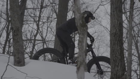 Fatbike-cyclist-riding-down-a-forest-trail