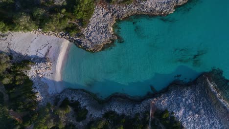 Aerial-view-of-Es-Talaier-virgin-Beach-with-clear-blue-water-in-Menorca-Spain