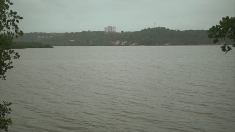 A-scenic-shot-looking-out-over-an-empty-Mondovi-River-on-a-grey-gloomy-and-miserable-day,-Goa,-India