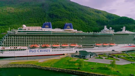 Aerial-view-of-P-and-O-Cruises-Ship-in-Port-of-Flam-with-green-mountains-in-background,Norway