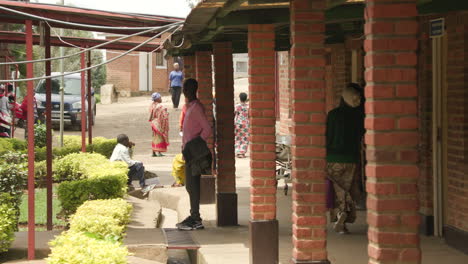 wide-shot-pan-of-people-walking-through-hospital-courtyard-in-Rural-Rwanda