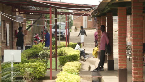 Weitwinkelaufnahme-Von-Menschen,-Die-Durch-Den-Krankenhaushof-Im-Ländlichen-Ruanda-Gehen