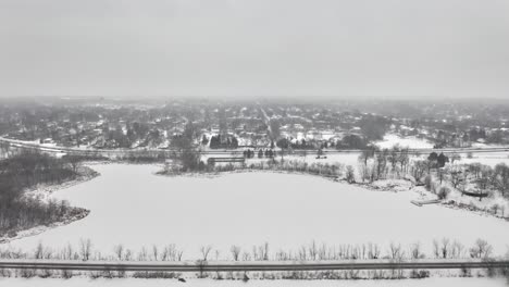 Dramatic-aerial-footage-over-Lake-Cornelia-Edina,-Minnesota-after-heavy-snow-turns-the-landscape-into-a-winter-wonderland