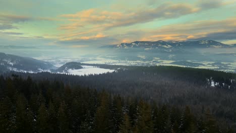 Drone-Pullback-shot-over-the-BC-Forests-close-to-Enderby-,-British-Columbia-during-sunset-in-Winter