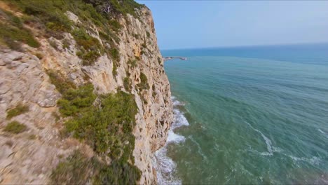 Picturesque-aerial-view-flying-along-the-scenic-Mediterranean-coastline-in-Garraf,-Spain
