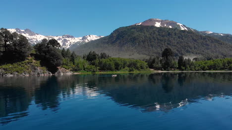 AERIAL---Snowcapped-mountain-next-to-Hermoso-Lake,-Neuquen,-Argentina,-truck-right