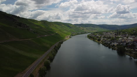 Sideways-flight-over-lake-Moselle-next-to-village