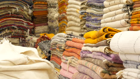 Heaps-of-traditional-Moroccan-carpets-for-sale-at-Marrakesh-marketplace