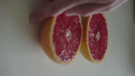 Flipping-a-half-of-a-juicy-grapefruit
