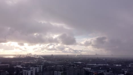 Post-apocalyptic-city-scene-on-an-overcast-winter-day,-aerial-tilt-up-over-buildings