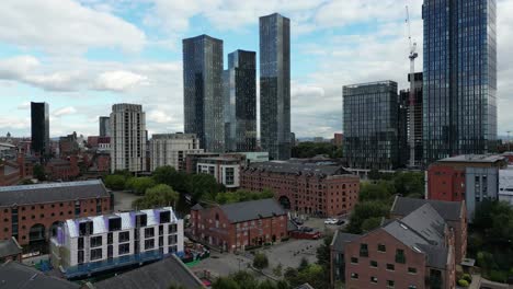 Aerial-drone-flight-over-the-rooftops-of-Castlefield-Quays-heading-up-and-towards-Elizabeth-Tower-giving-a-view-of-Manchester-City-Centre