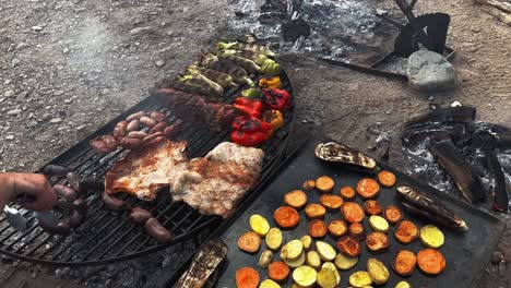 Chef-preparing-a-a-delicious-grilled-vegetables,-meat-and-blood-sausages-in-Argentine-grill,-south-american-grilled-style