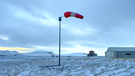 Wind-sock-slowly-moving-on-Blönduos-airfield-in-Iceland-on-a-cold-cloudy-winter-day