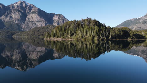 AERIAL---Mirror-reflection-on-lake-in-Rio-Negro,-Patagonia,-Argentina,-circle-pan