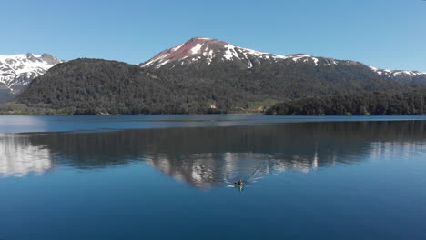 AERIAL---Snowcapped-mountain-next-to-Hermoso-Lake,-Neuquen,-Argentina,-static-shot