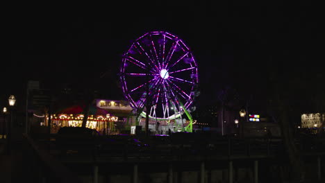 A-Wide-shot-of-a-Ferris-wheel-spinning-at-night-from-a-distance