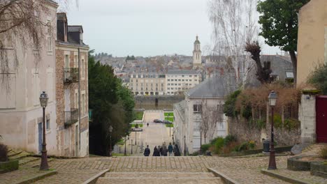 People-Climbing-Down-The-Stone-Steps-In-Cathédrale-Saint-Maurice,-Angers,-Maine-et-Loire,-France