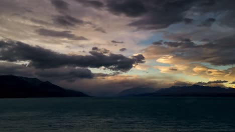 Day-to-Night-time-lapse-of-Lake-Pukaki,-New-Zealand-with-heavy-storm-clouds-moving-past