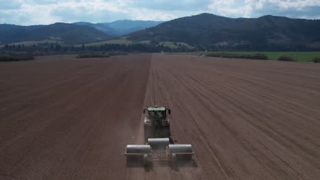 Food-Industry-Concept,-Aerial-View-of-Tractor-Preparing-Farming-Land-For-Another-Seeding-Season