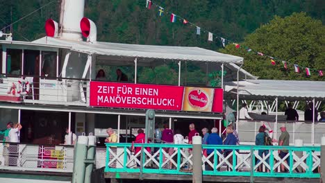 Closeup-of-passengers-boarding-a-steamboat-on-Lake-Wörthersee-in-order-to-get-ready-for-a-boat-trip-on-the-lake