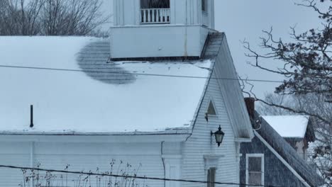 Communal-church-Monson-covered-in-snowfall-ascending-aerial