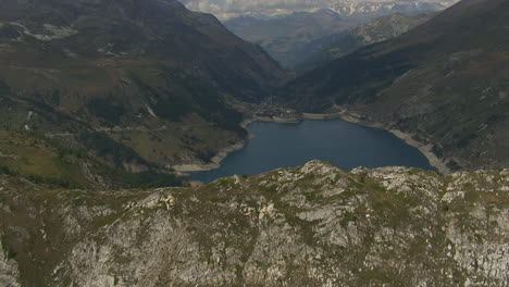 Lake-in-Mountain-Peaks-of-the-French-Alps,-Vanoise-National-Park---Aerial-Drone-Flight