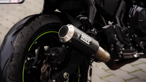 Kawasaki-Ninja-650-Black-Motorcycle-Wheel-and-Exhaust,-Close-Up-Shot
