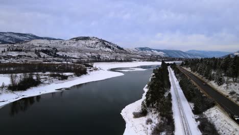 The-Thompson-River-and-Highway-1,-with-Wintery-Mountains-in-Kamloops,-British-Columbia