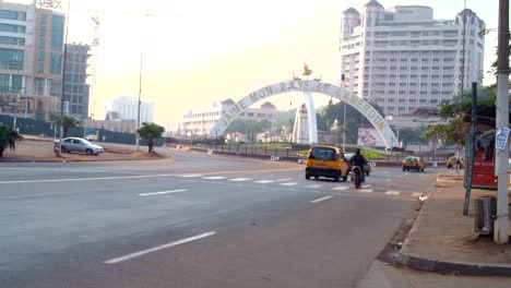 Traffic-flow-by-famous-roundabout-landmark-downtown-Yaoundé,-cameroon