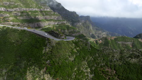 Cars-Driving-Through-Dangerous-Mountain-Pass-To-Rocha-do-Navio-Waterfall-In-Madeira,-Portugal