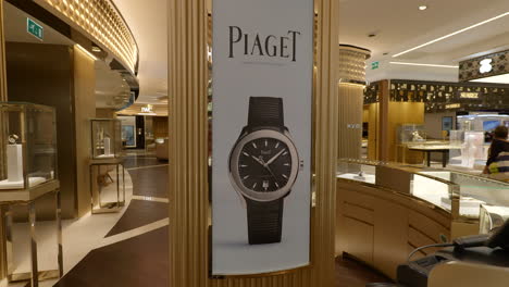 Inside-elegant-watch-shop-with-Piaget-retail-sales-display-column-behind-customer-counter