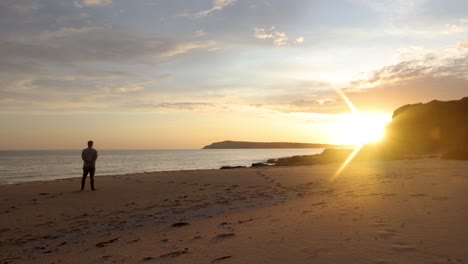 Ein-Mann,-Der-Am-Strand-Steht-Und-Einen-Wunderschönen-Sonnenuntergang-In-Australien-Betrachtet