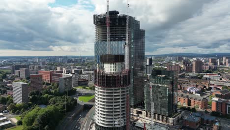Aerial-drone-flight-panning-around-new-skyscraper-developments-under-construction-in-Manchester-City-Centre