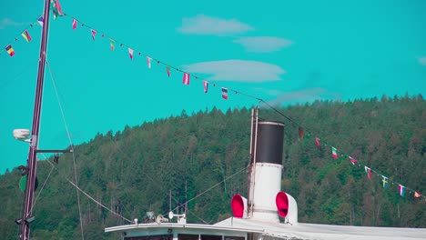 Smoke-coming-out-of-a-chimney-of-a-steamboat-on-Lake-Wörthersee,-Carinthia,-Austria