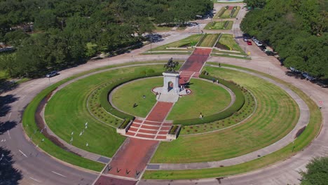 Aerial---Sam-Houston-Statue-in-Houston,-TX-on-sunny-day-with-people