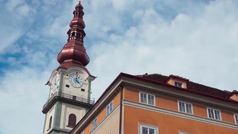Part-of-the-old-town-hall,-today-called-Palais-Rosenberg-and-tower-of-the-parish-church-in-Klagenfurt